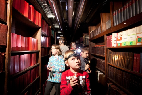 children walking between bookcases